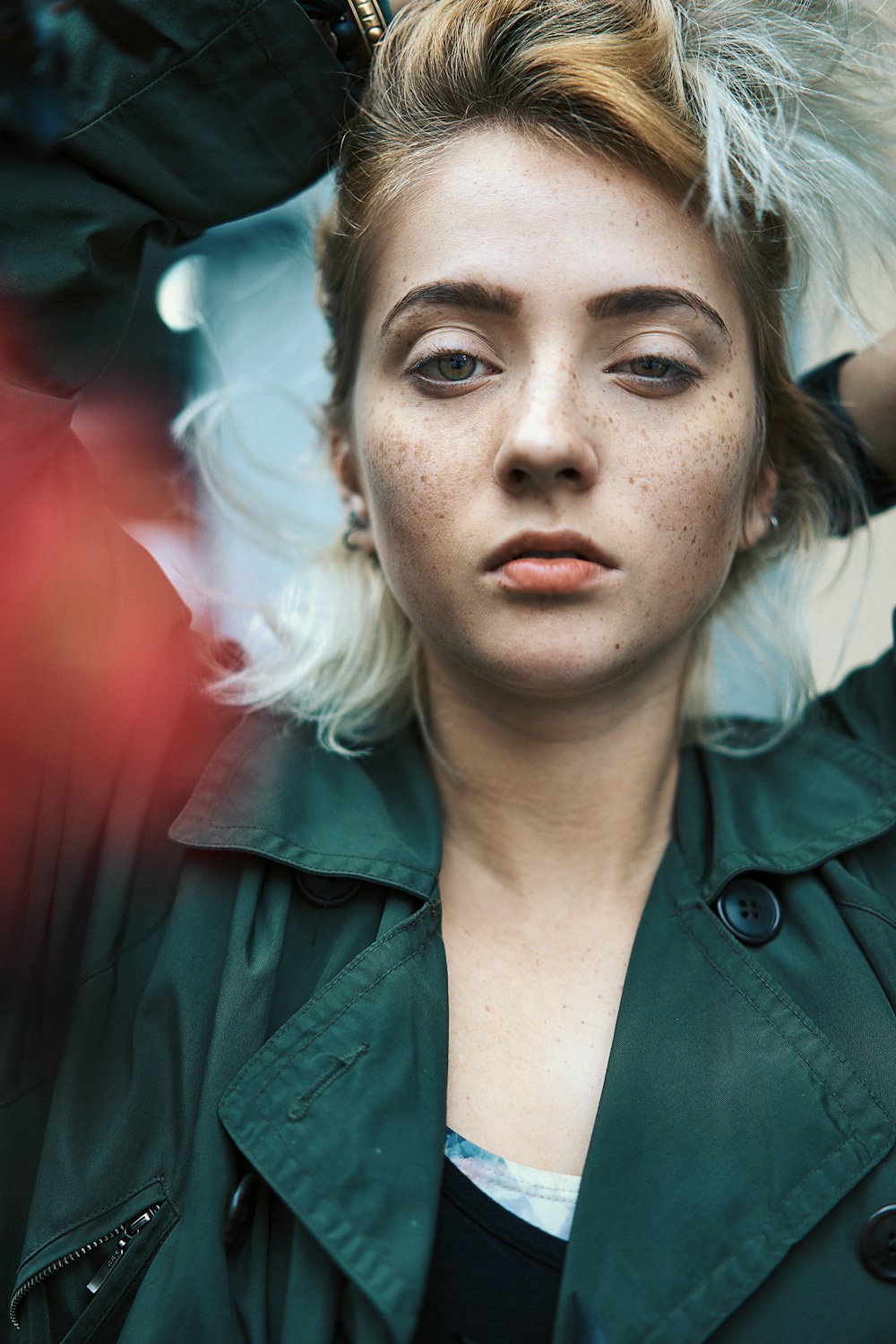 woman in green jacket with white hair