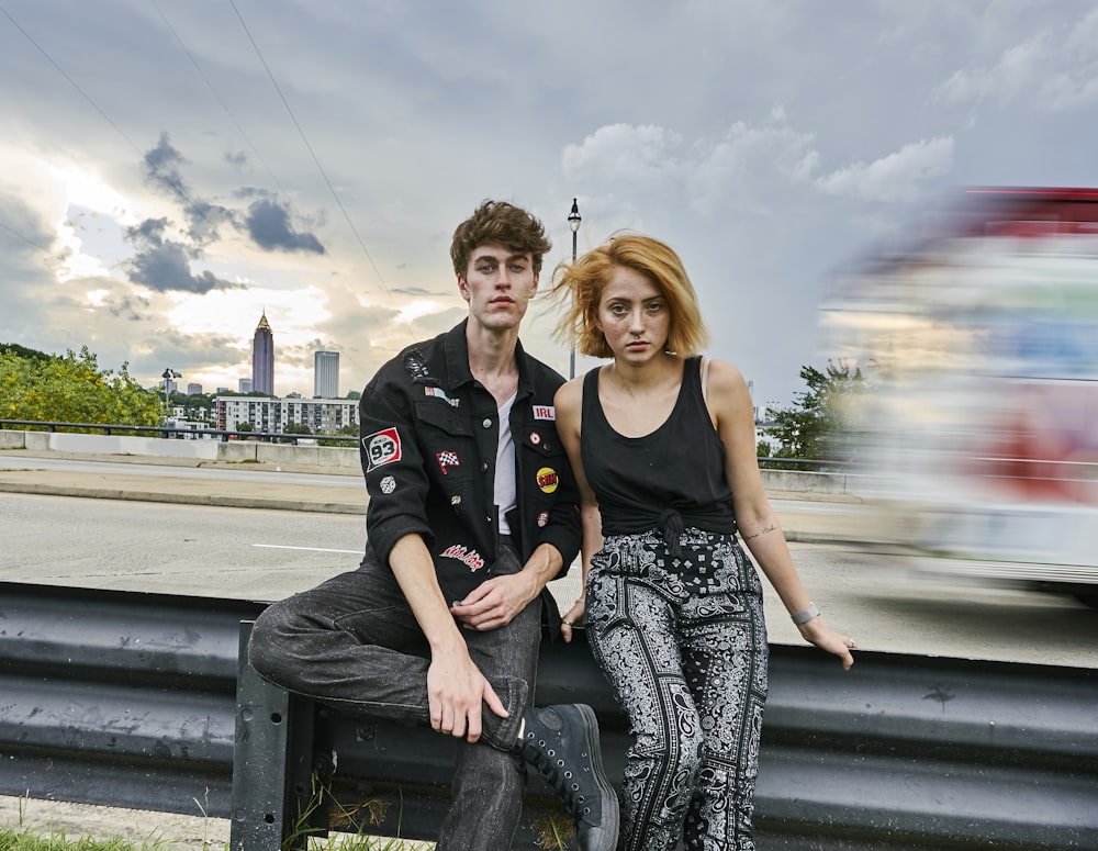 man and woman sitting on bench