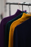 black and blue clothes hanging on clothes hanger