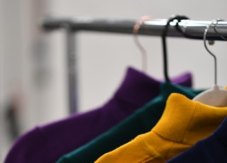 black and blue clothes hanging on clothes hanger