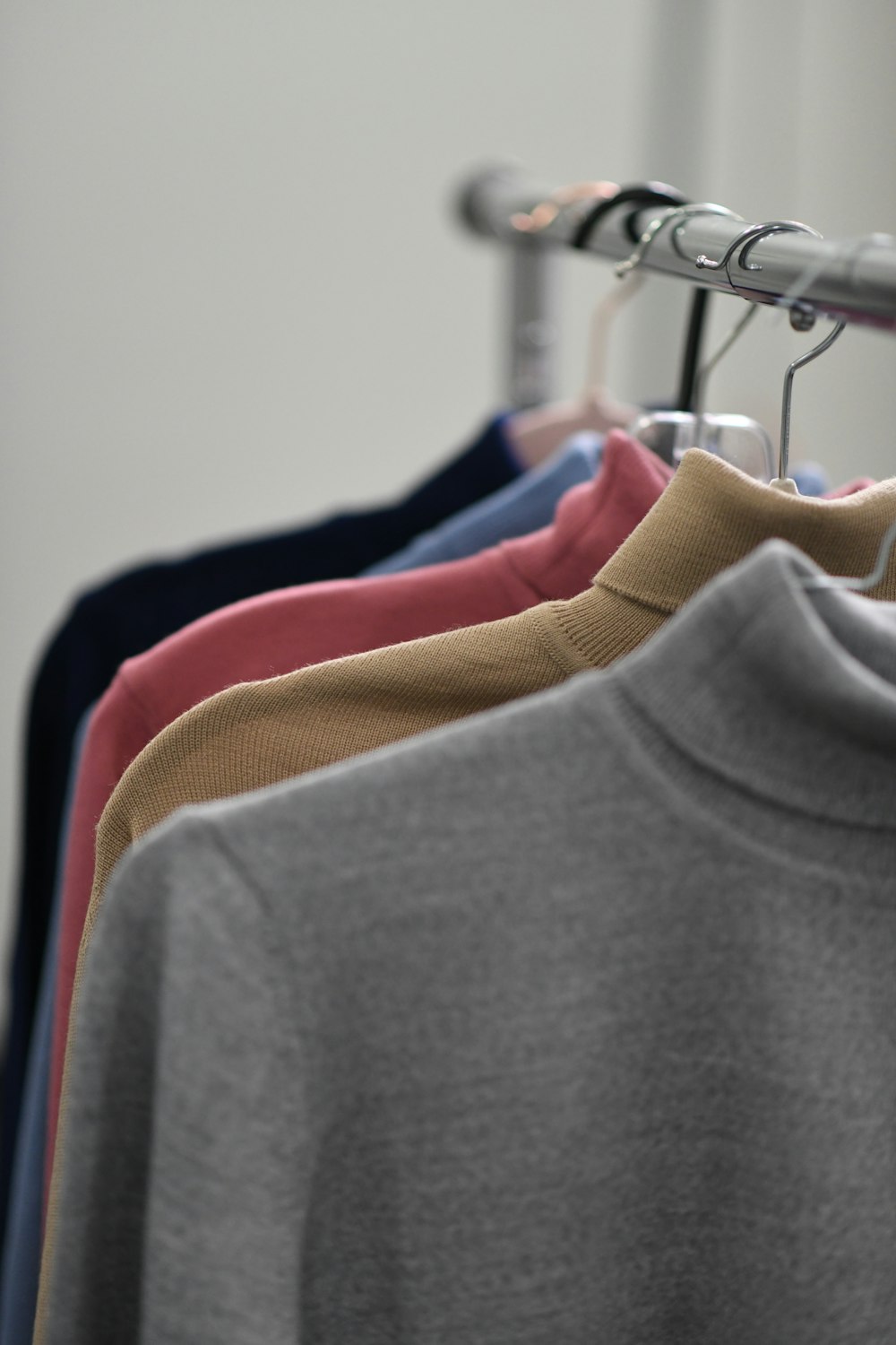 gray crew neck shirt on white clothes hanger