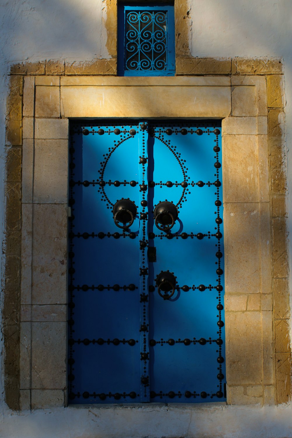 blue metal frame on brown brick wall