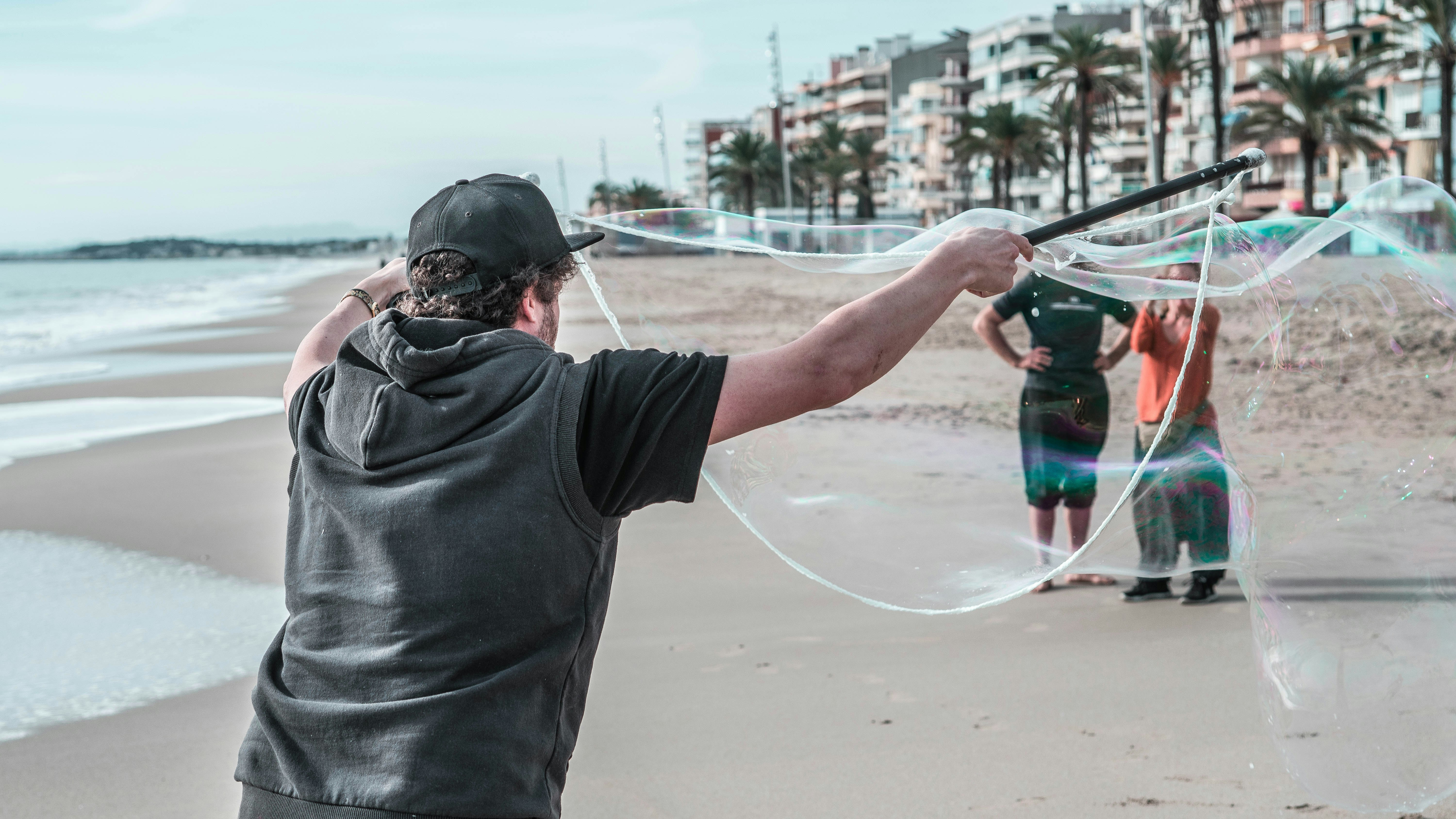 man in black t-shirt holding black and green fishing rod