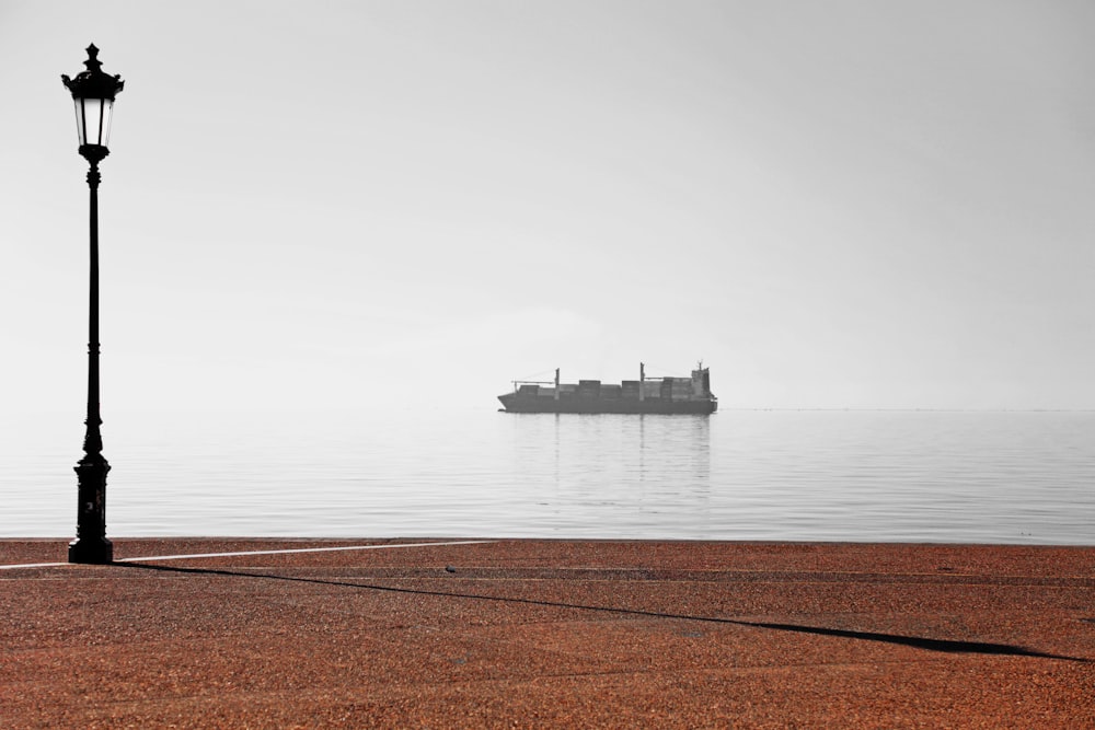 ship on sea under white sky during daytime