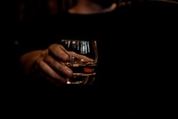 person holding clear drinking glass