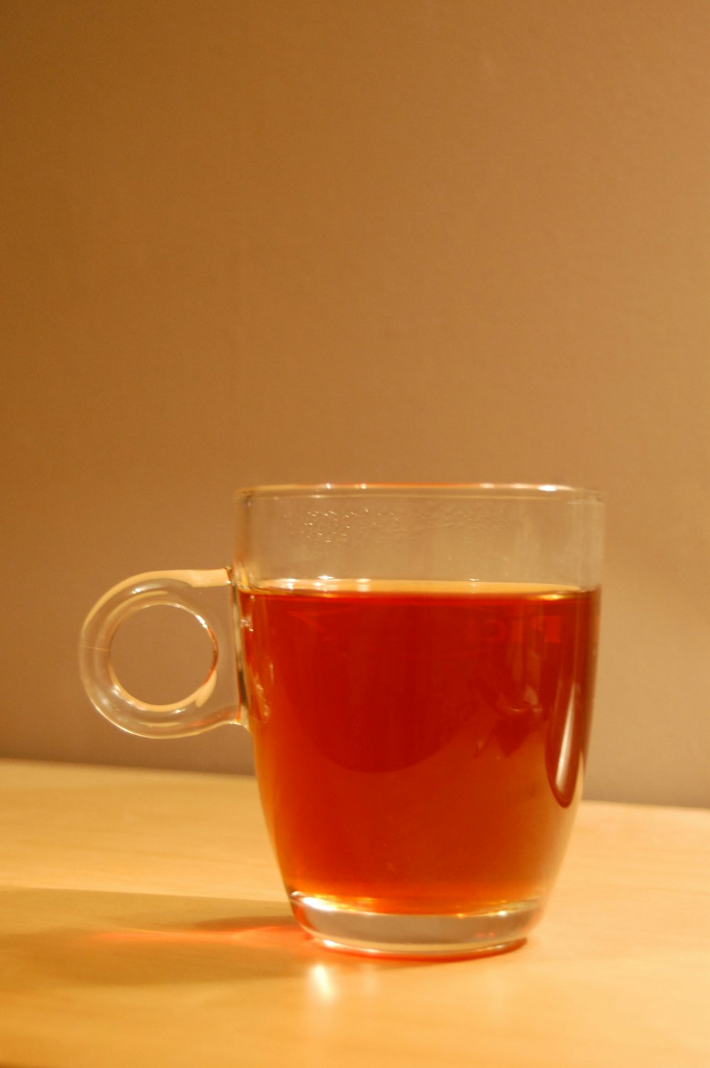 clear glass mug with brown liquid