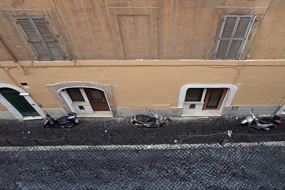 black car parked beside brown building