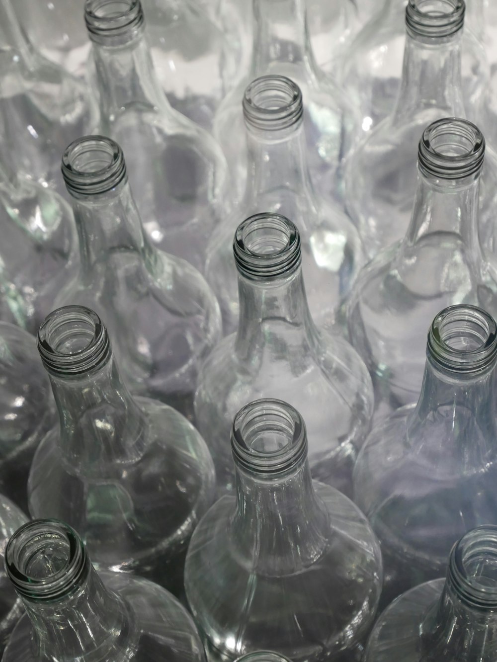 clear glass bottles on brown wooden table