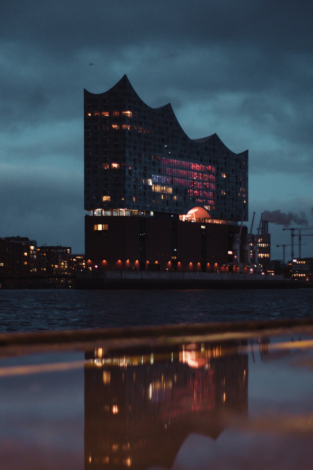 city skyline across body of water during night time