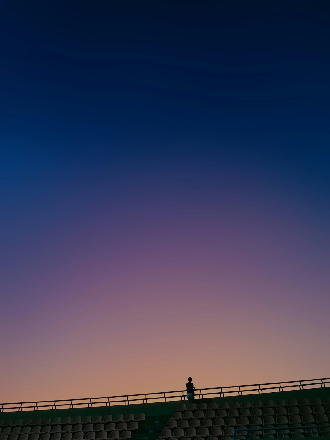silhouette of person standing on top of hill during daytime