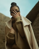 man in brown coat wearing black sunglasses
