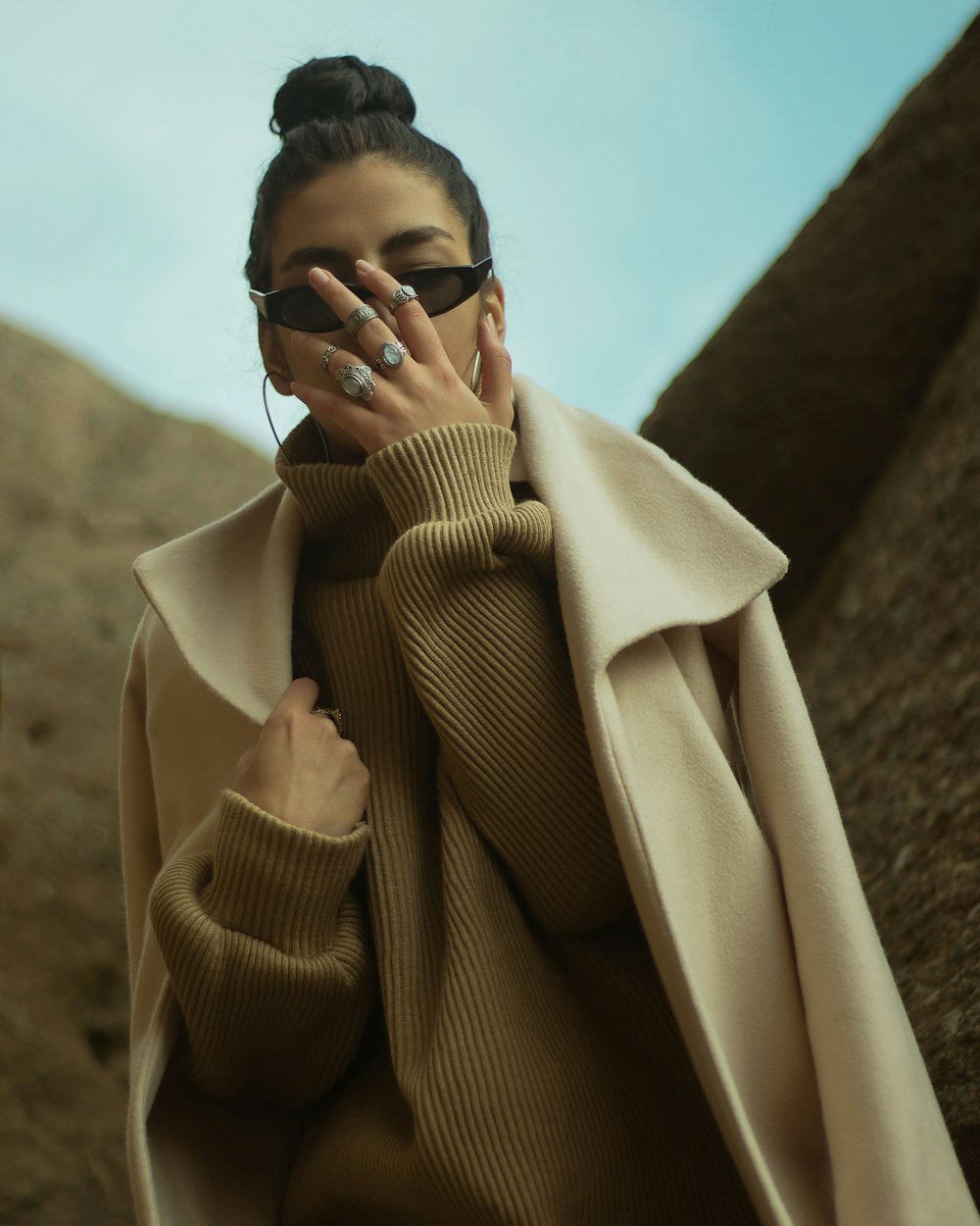 man in brown coat wearing black sunglasses