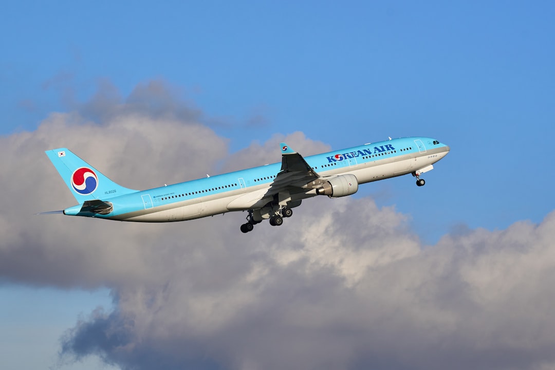 white and blue passenger plane in flight,