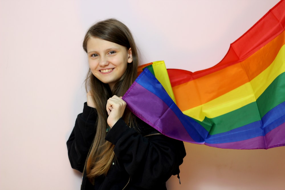 woman in black leather jacket holding multi colored umbrella