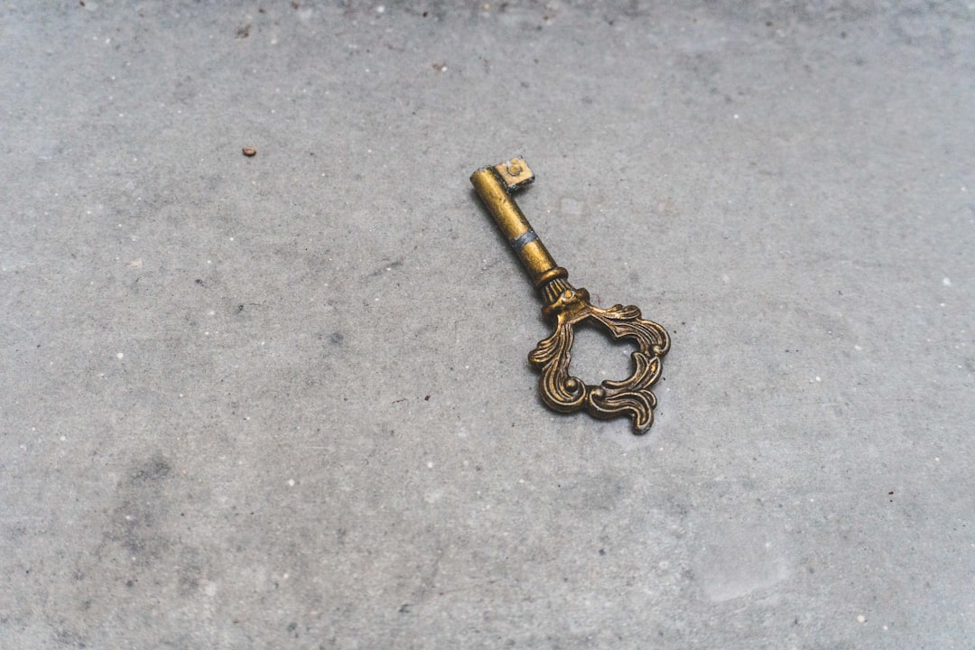  gold skeleton key on gray concrete floor key