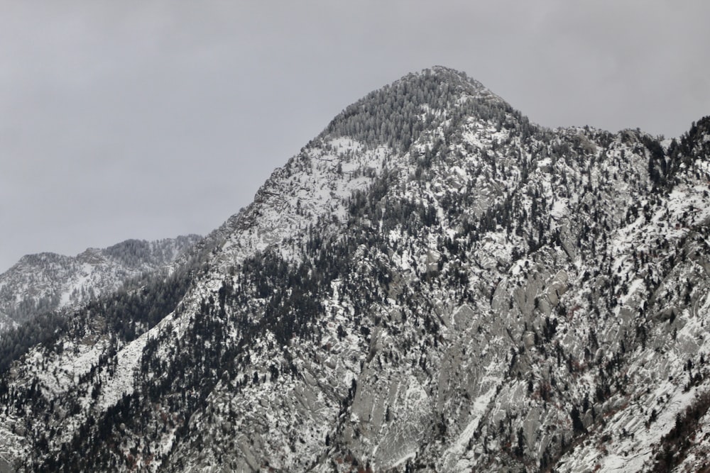 snow covered mountain under cloudy sky during daytime