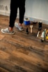 person in black pants and white and black nike renovating home