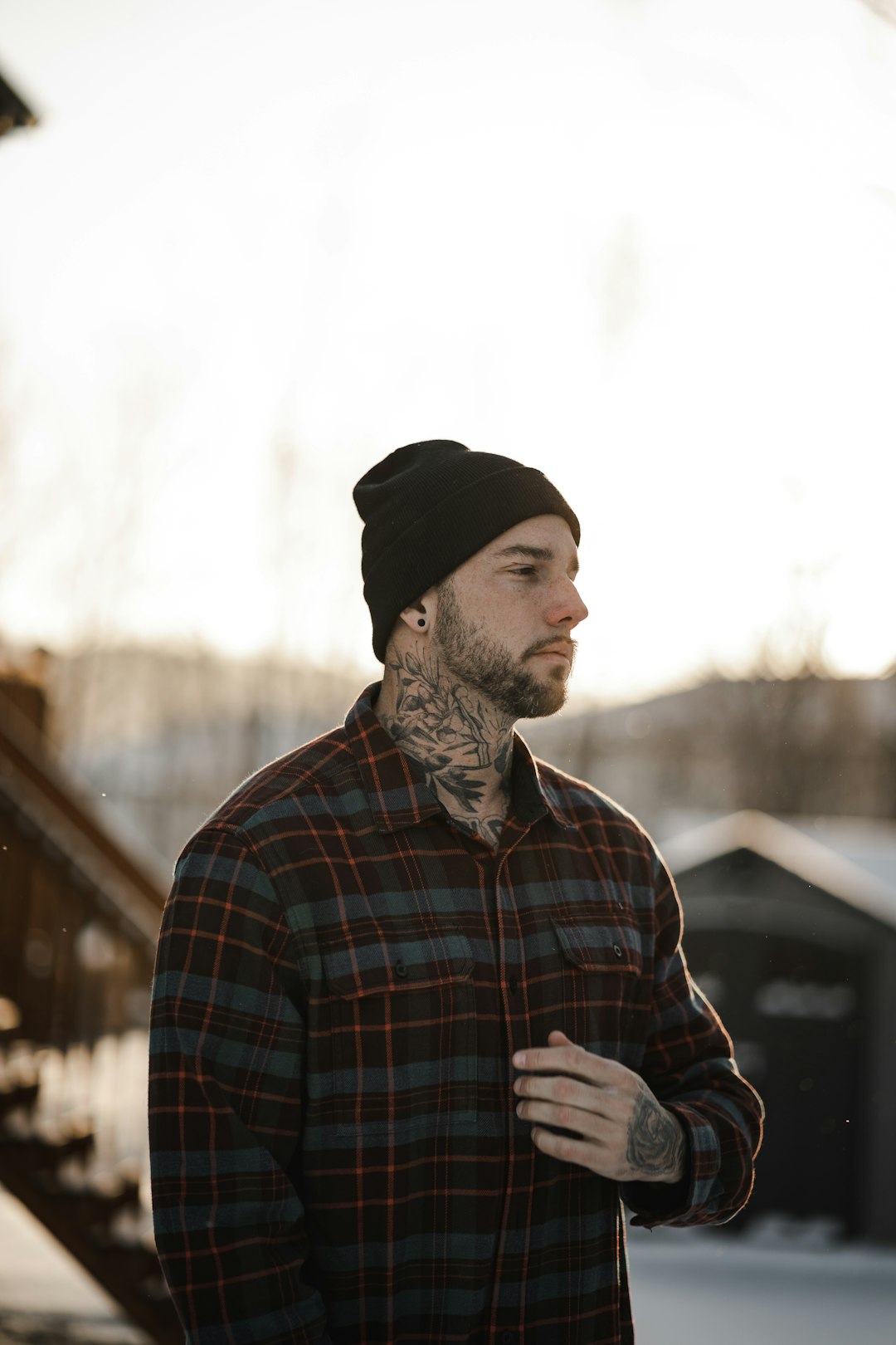 man in blue white and red plaid dress shirt wearing black knit cap