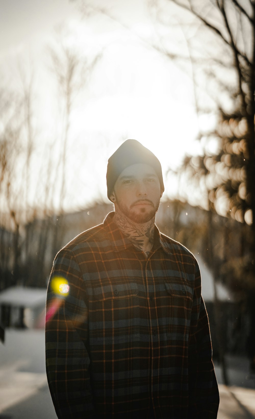 man in white knit cap and plaid dress shirt