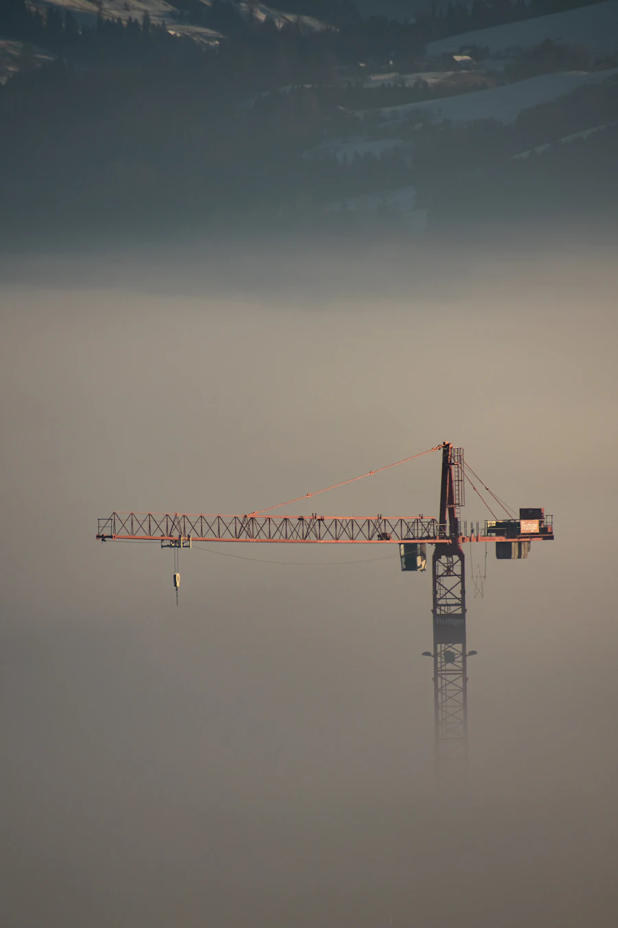 Rigger signaling a crane load on a marine construction site