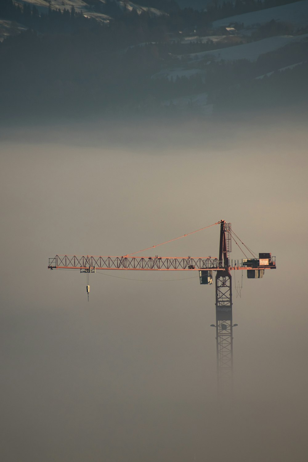 orange crane under blue sky