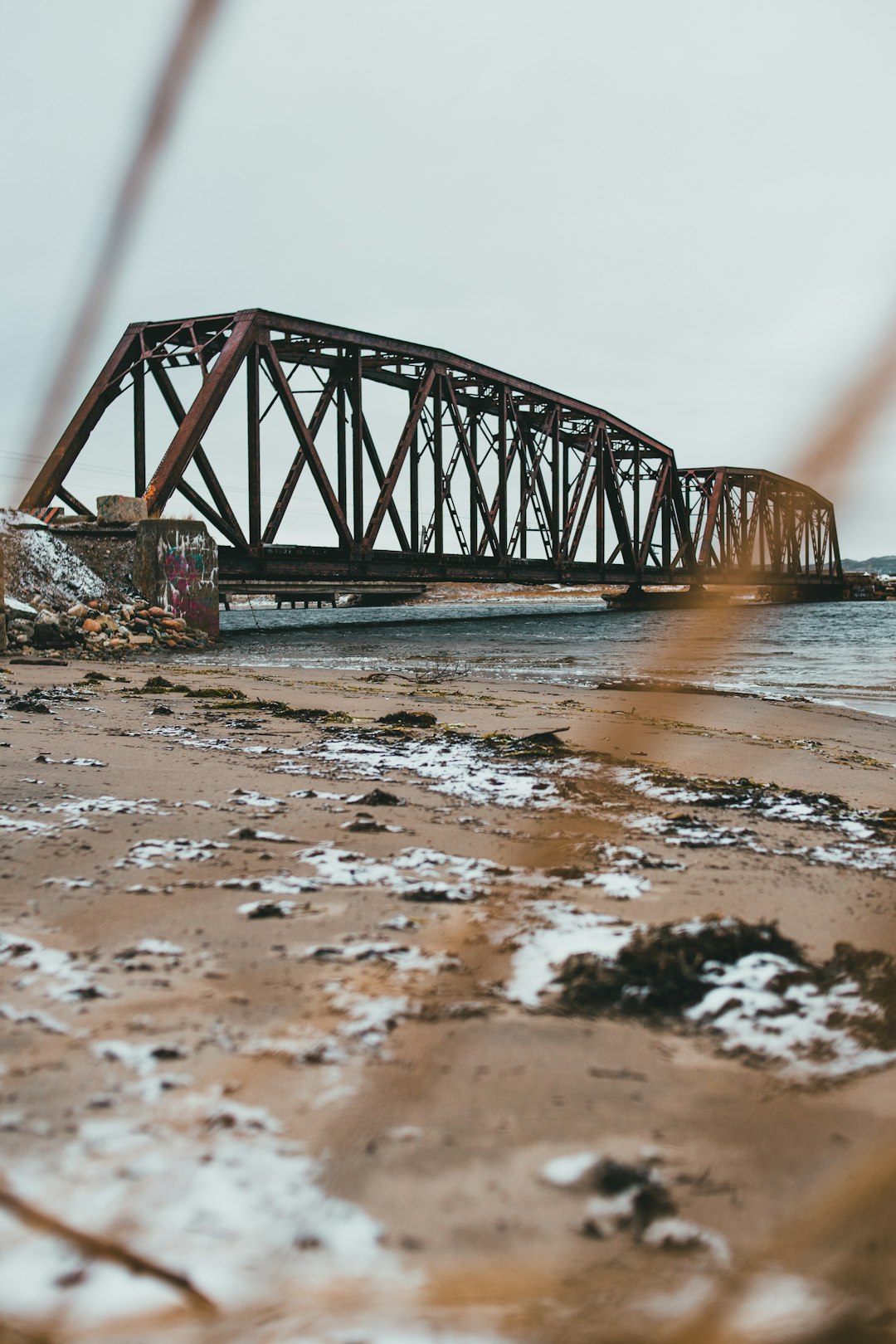 brown wooden bridge over body of water during daytime