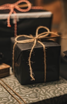 black and brown gift box on white and black floral textile