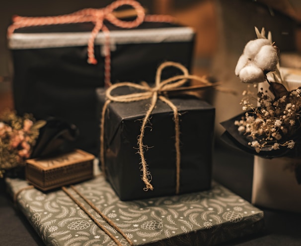 black and brown gift box on white and black floral textile