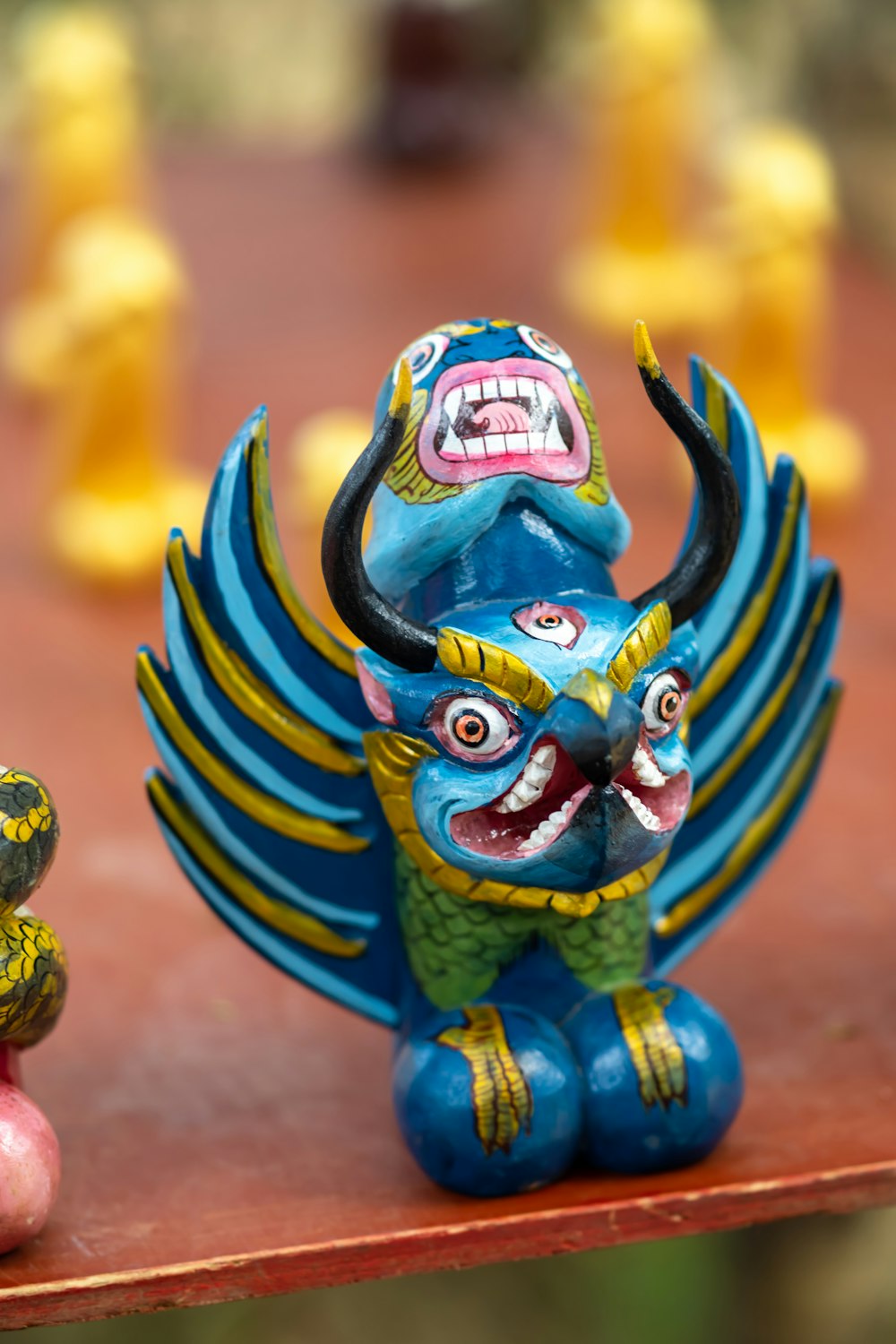 blue yellow and red dragon figurine