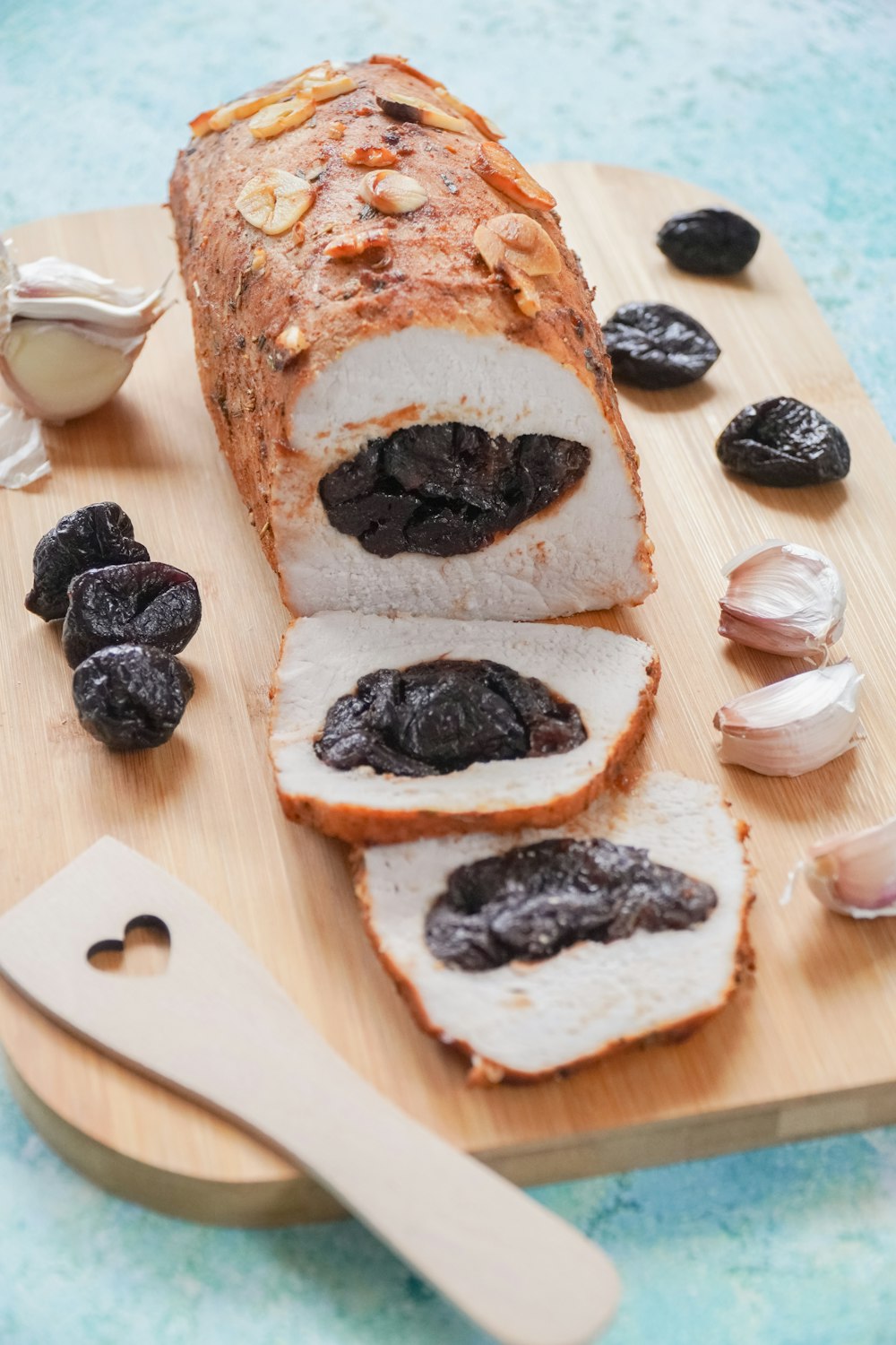 sliced bread with black berries on brown wooden chopping board