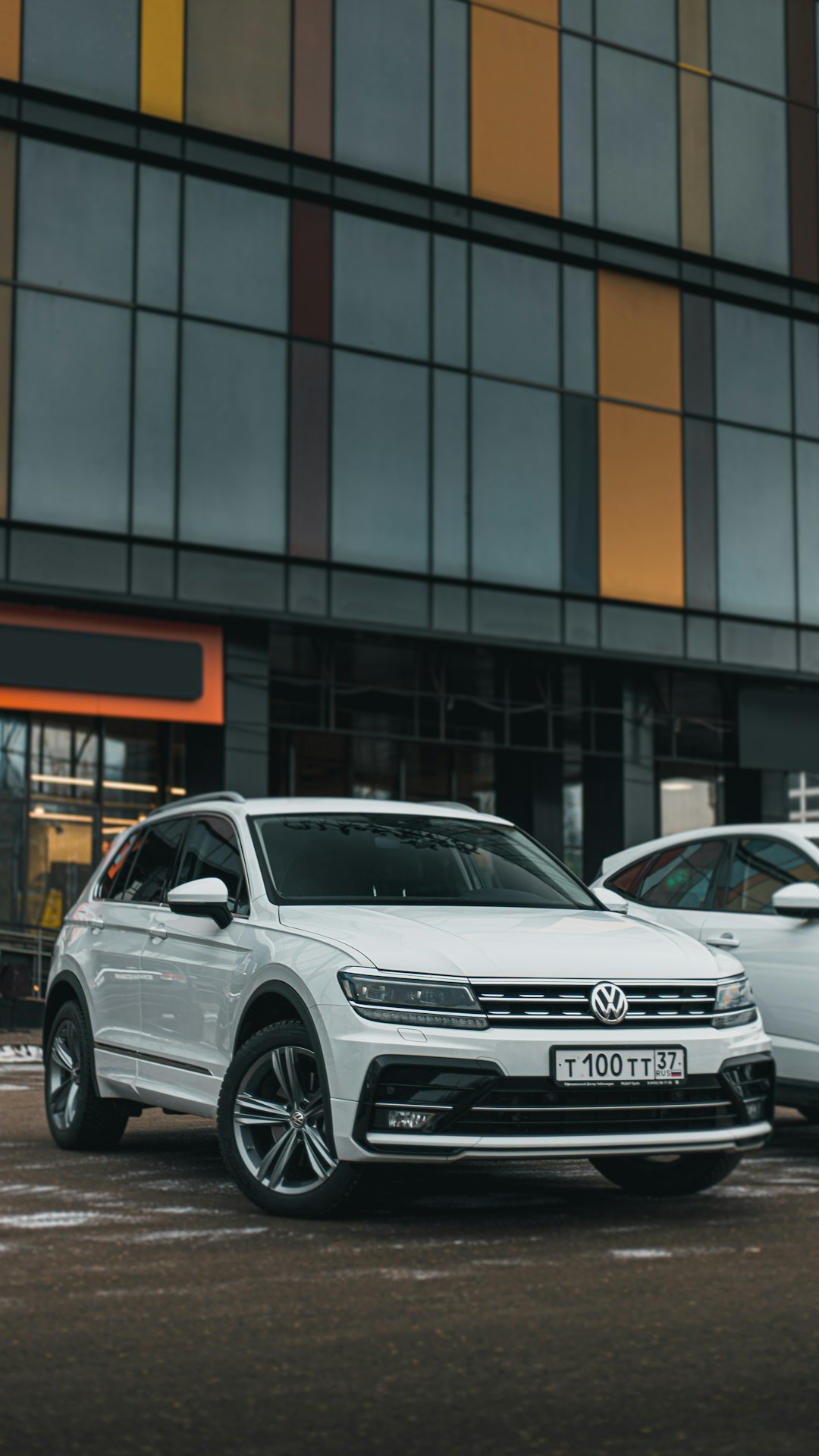 white honda sedan parked beside building during daytime