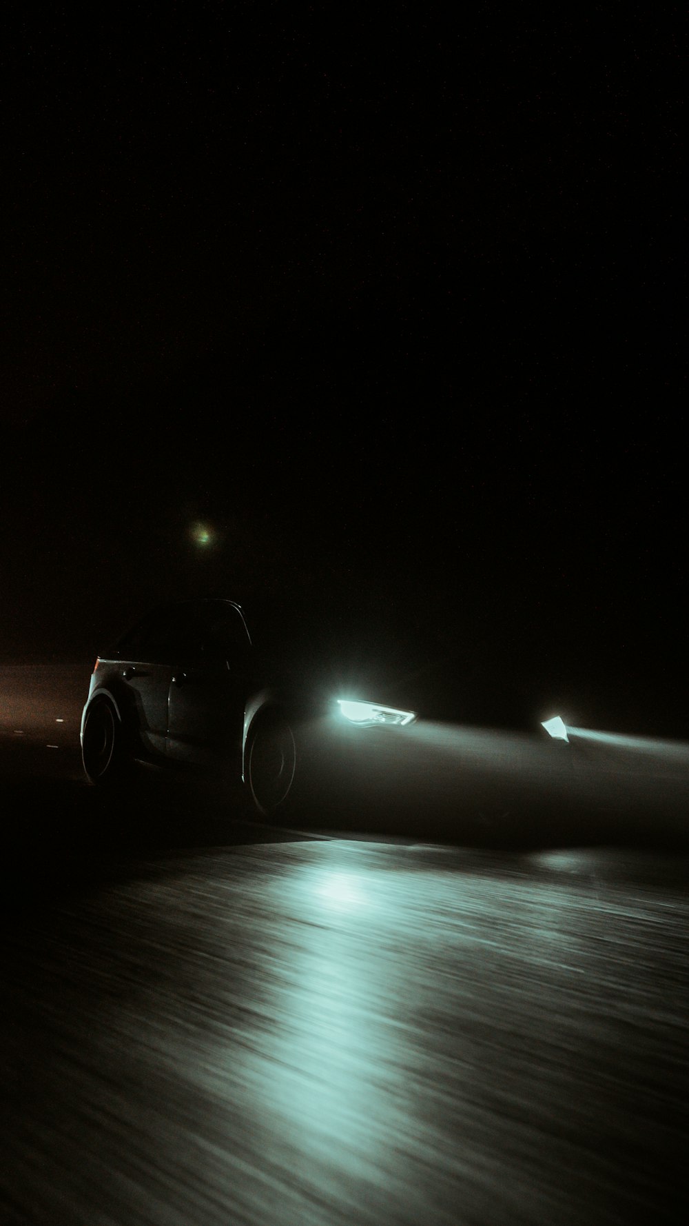 a car driving down a road at night