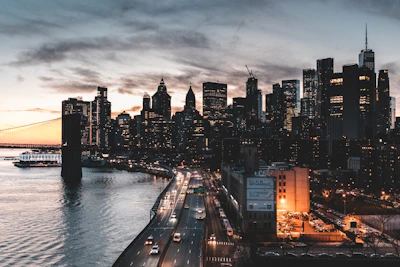 A city skyline showing modern bridges and highways during sunset.