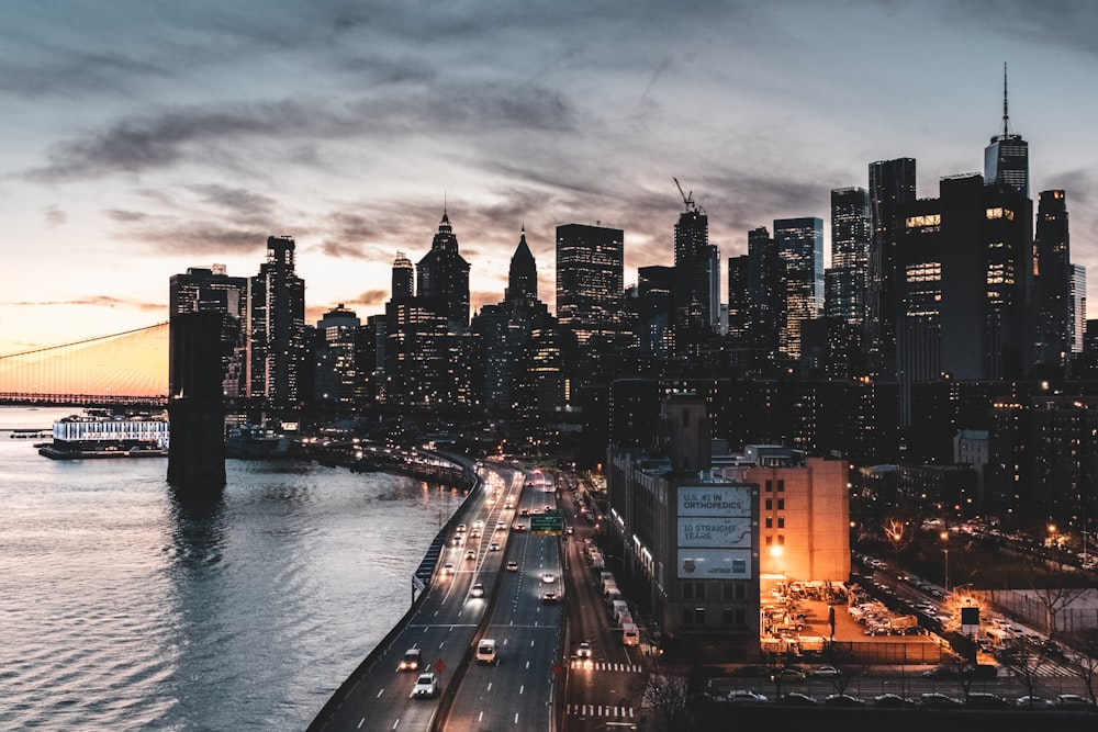 city buildings near body of water during night time