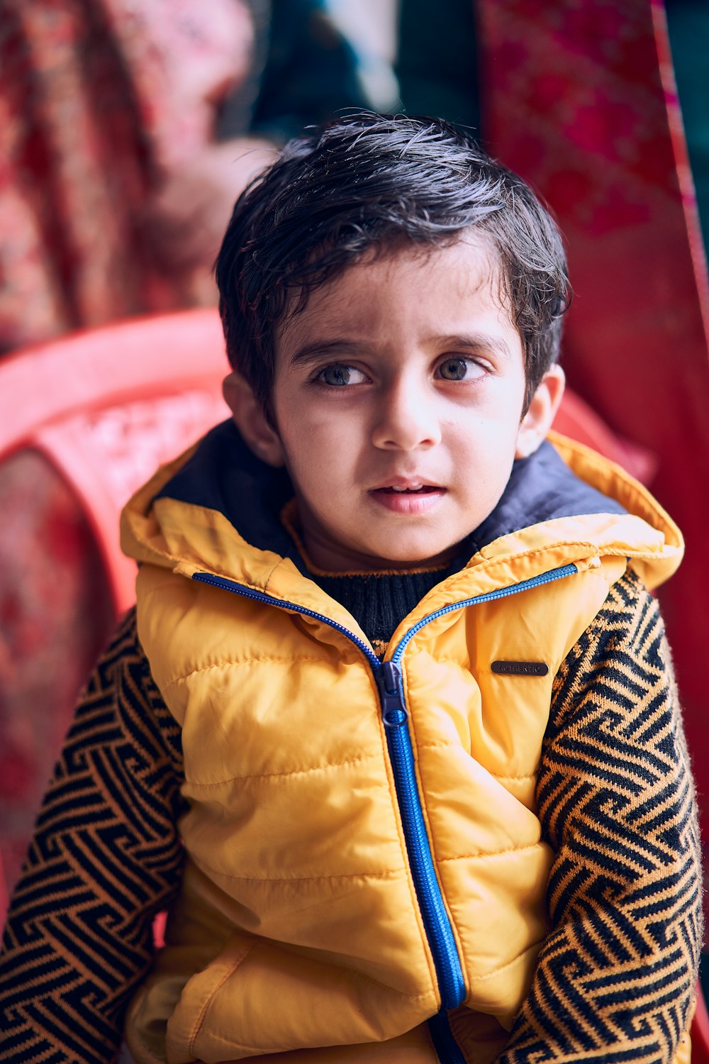 boy in yellow zip up jacket