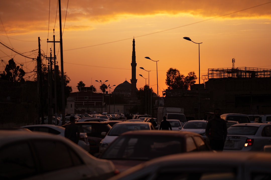 cars parked on parking lot during sunset