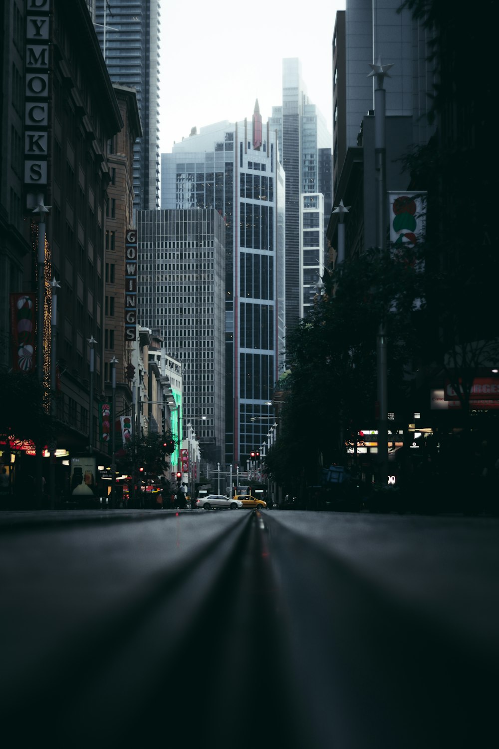 cars on road near high rise buildings during daytime