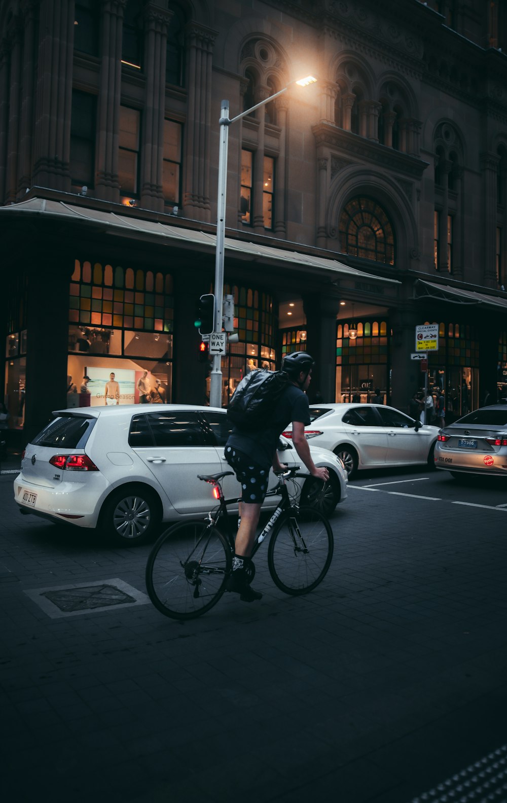 man in black jacket riding bicycle on road during daytime