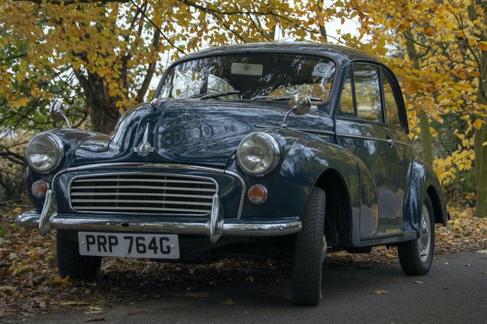 black classic car parked near trees during daytime