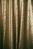 Shimmering metallic yarns glistening under warm light.