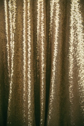 Shimmering metallic yarns glistening under warm light.