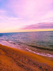 A playful sun emoji floating above a minimalist beach collage with soft pastel colors.