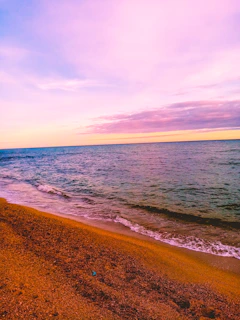 A playful sun emoji floating above a minimalist beach collage with soft pastel colors.