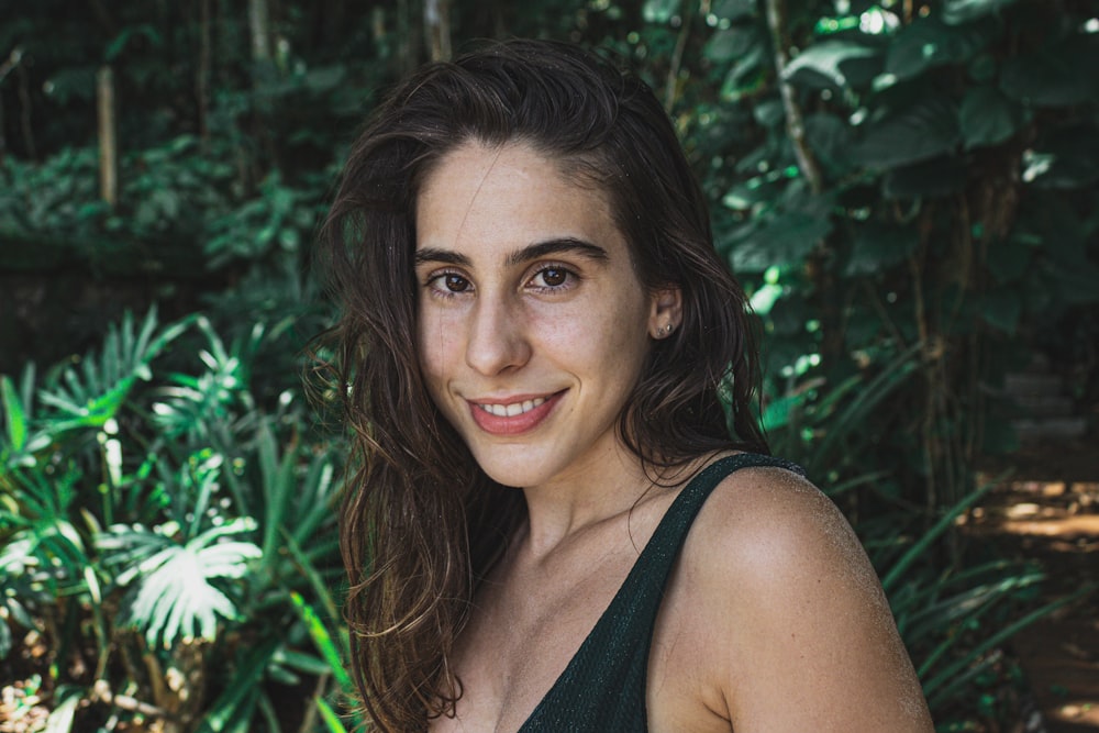 woman in black tank top smiling