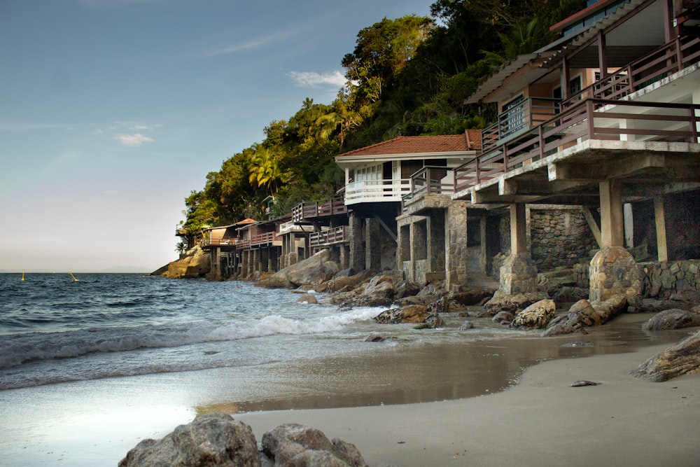 white and brown house near body of water during daytime