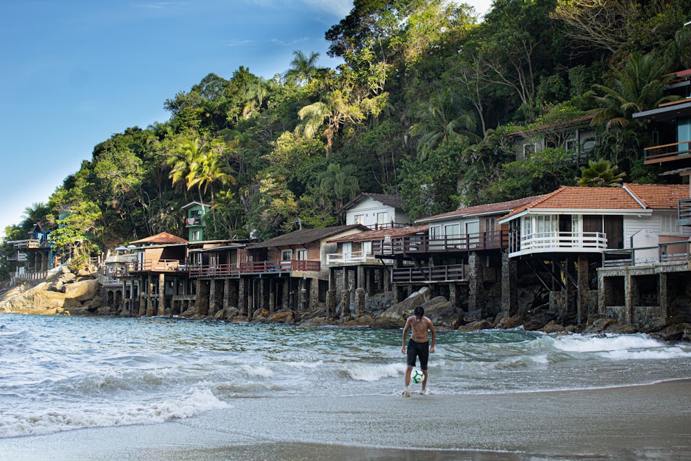 man and woman walking on beach during daytime