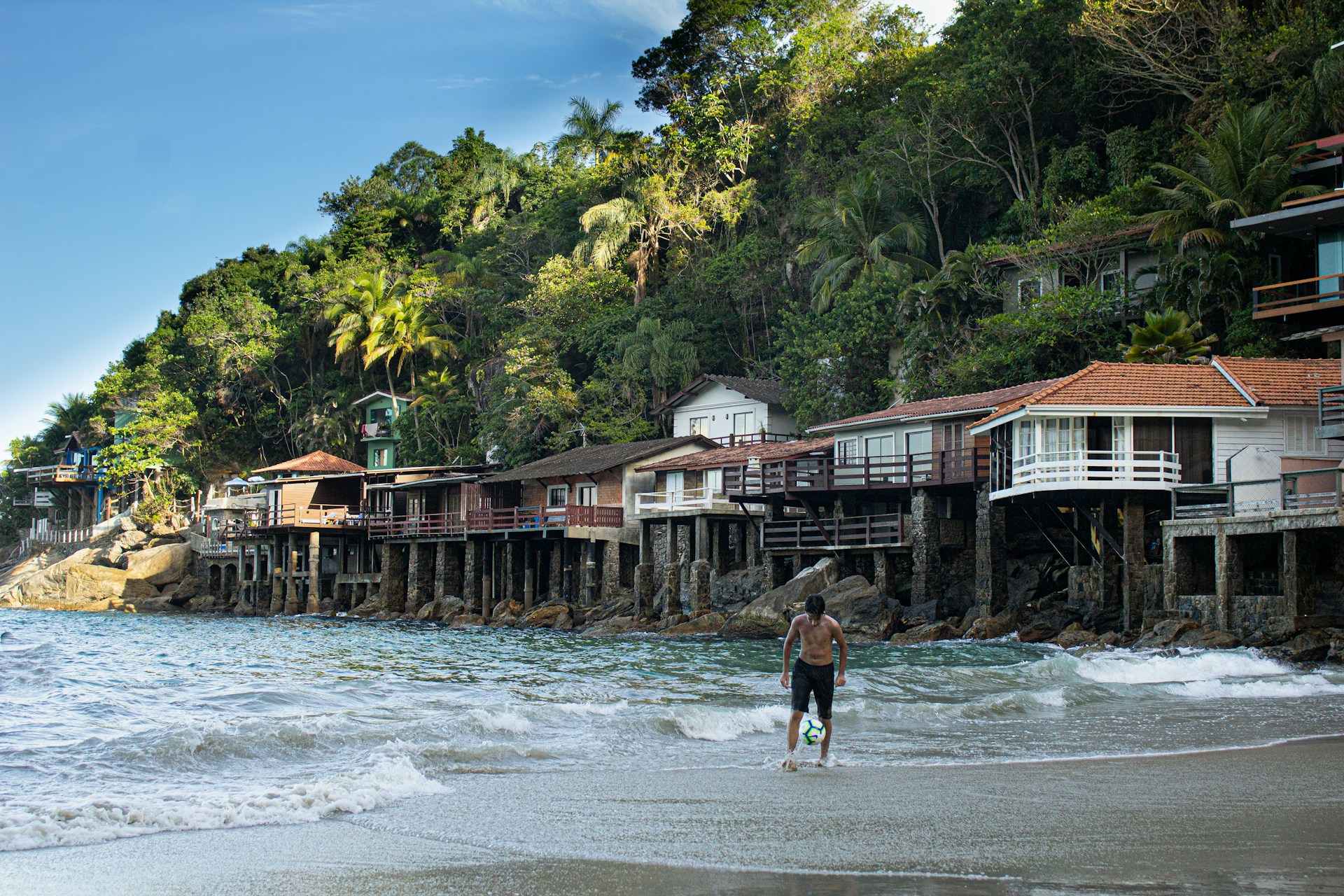 man and woman walking on beach during daytime