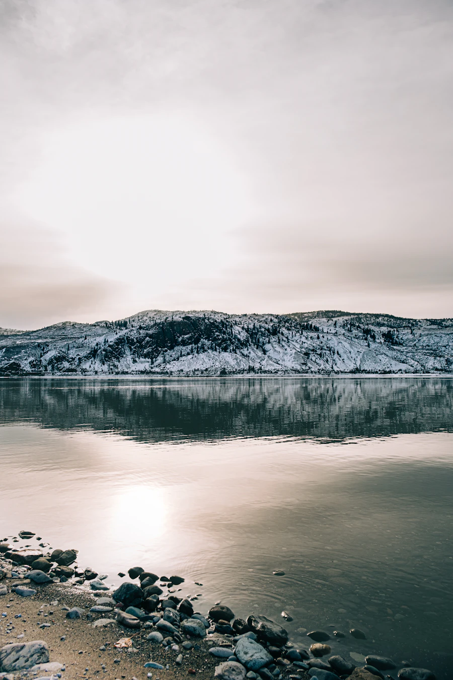 Snow on the hills above the water near Kamloops BC