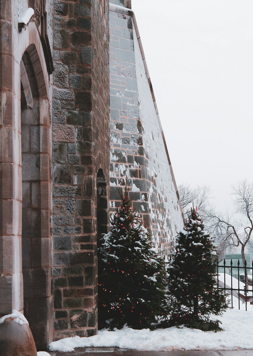 brown brick wall near green trees during daytime