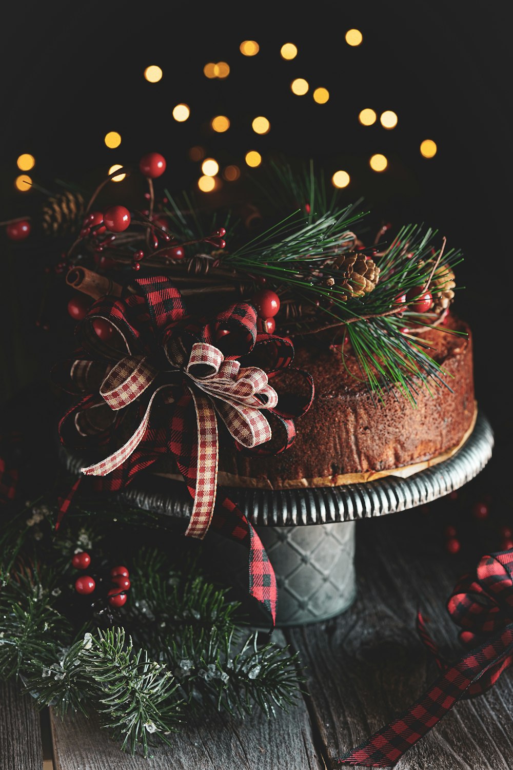 brown and white cake with red and white ribbon on brown wooden table